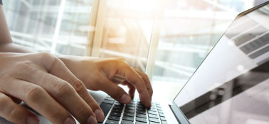 hands on keyboard of laptop